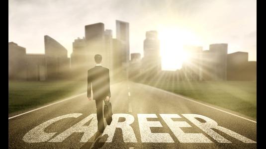 Person walking on road towards city skyline with 